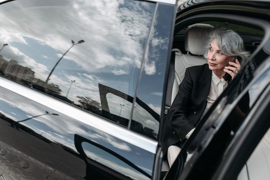 Driver sitting in her car talking on the phone